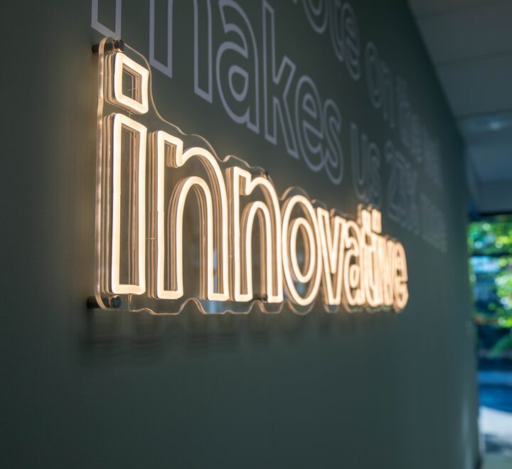 Led sign on the wall at The Village saying "Innovative".