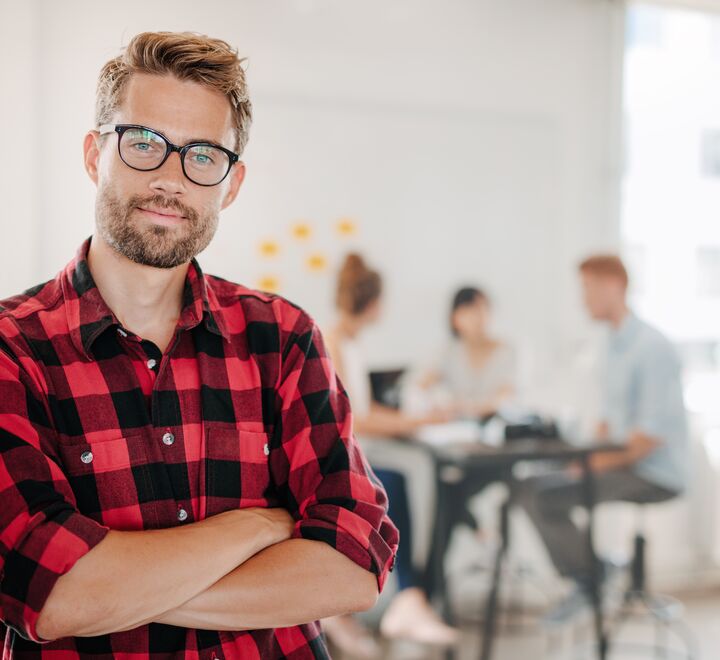 Employees who have a say in how they do their jobs are happy and perform better. Illustration photo of a manager in front with the employees in the background.