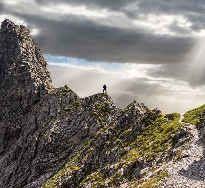 Man standing at the top of a mountain with a great view..