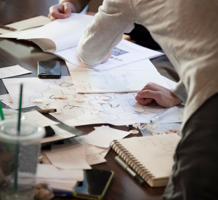Persons pointing at documents