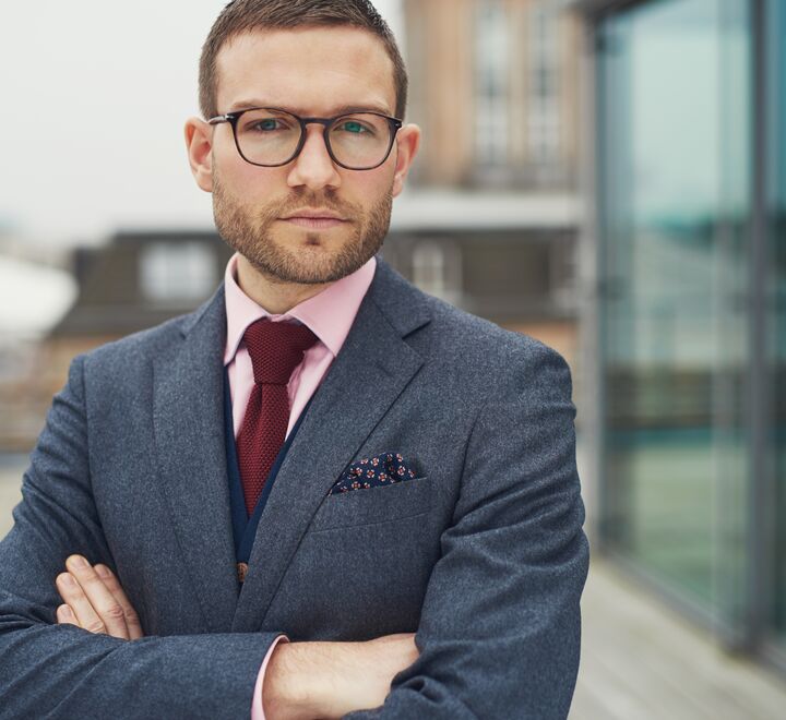 Confident businessman standing outside office