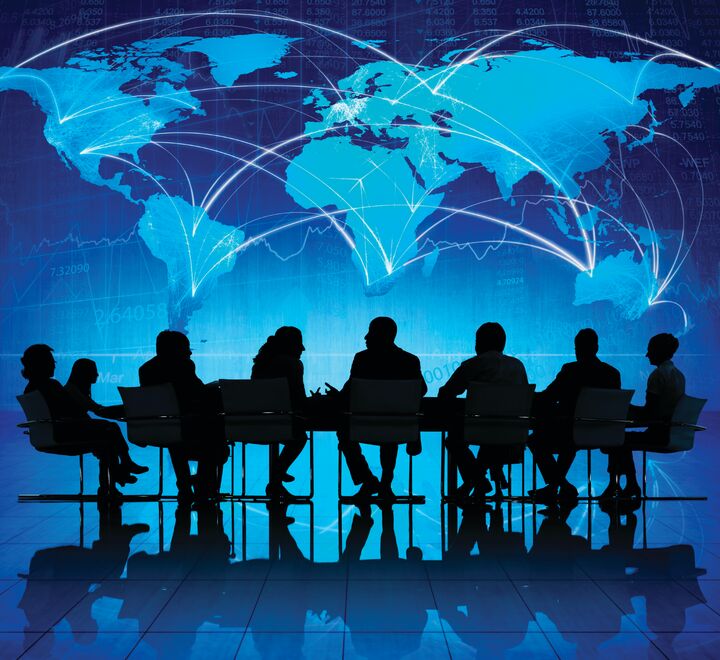 World map with people sitting at a table