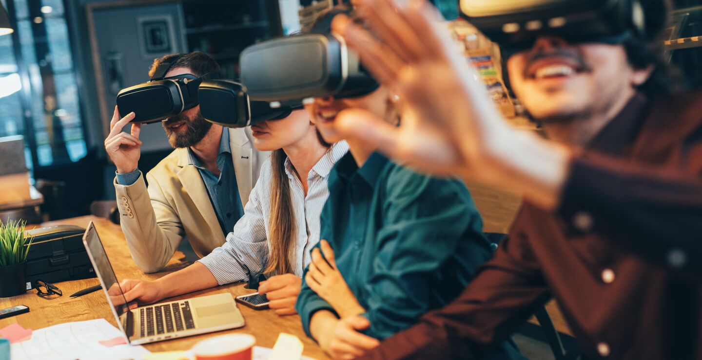 Group of people with VR headsets in a business meeting