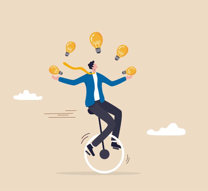 Businessman riding unicycle juggling lightbulbs.