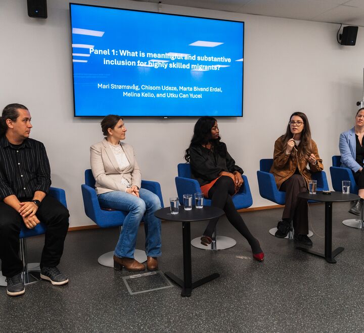 Image of the panel discussion. Five people sitting and debating
