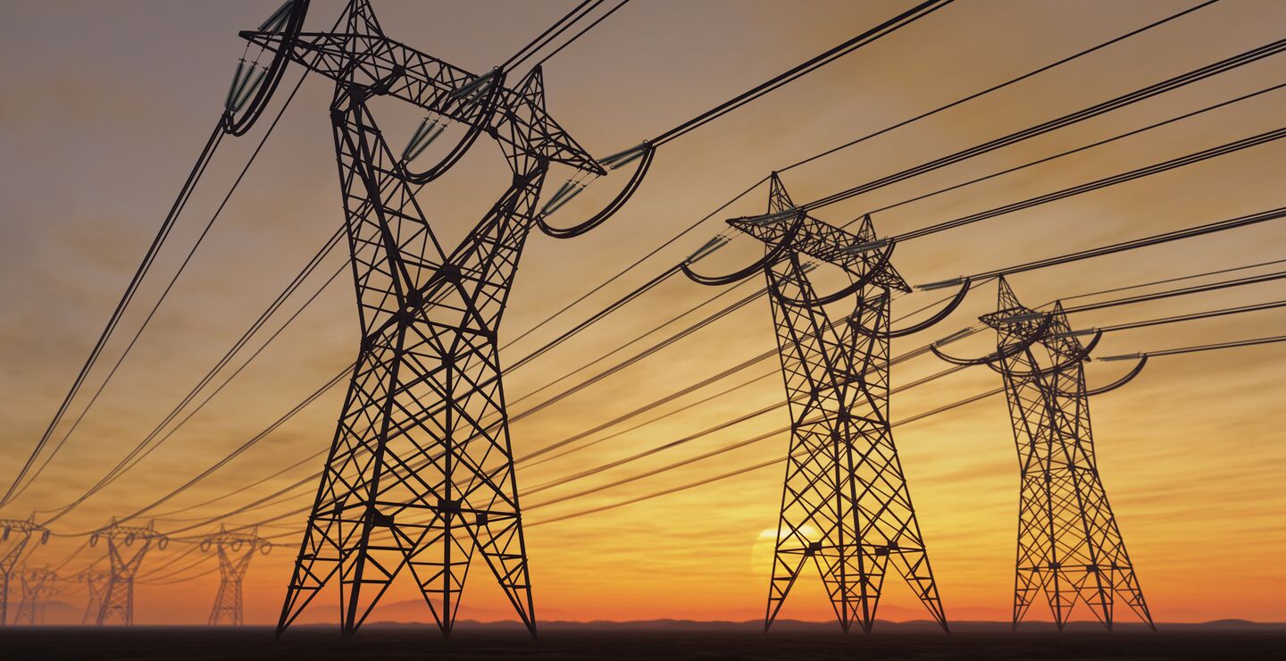 Power lines against setting sun