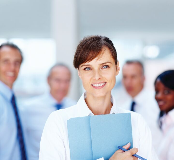 A doctor with a group of doctors behind her