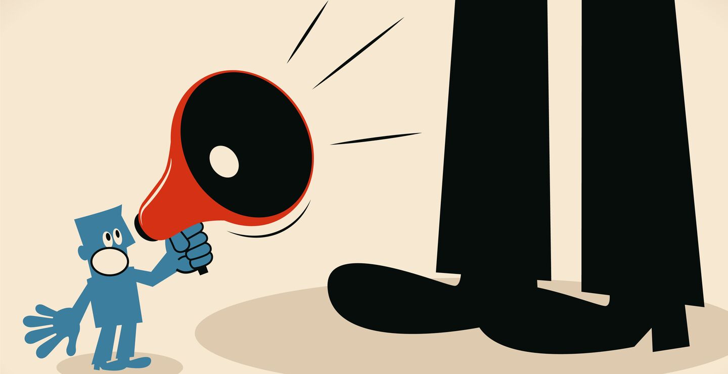 Illustration of small man with microphone shouting a giant black figure