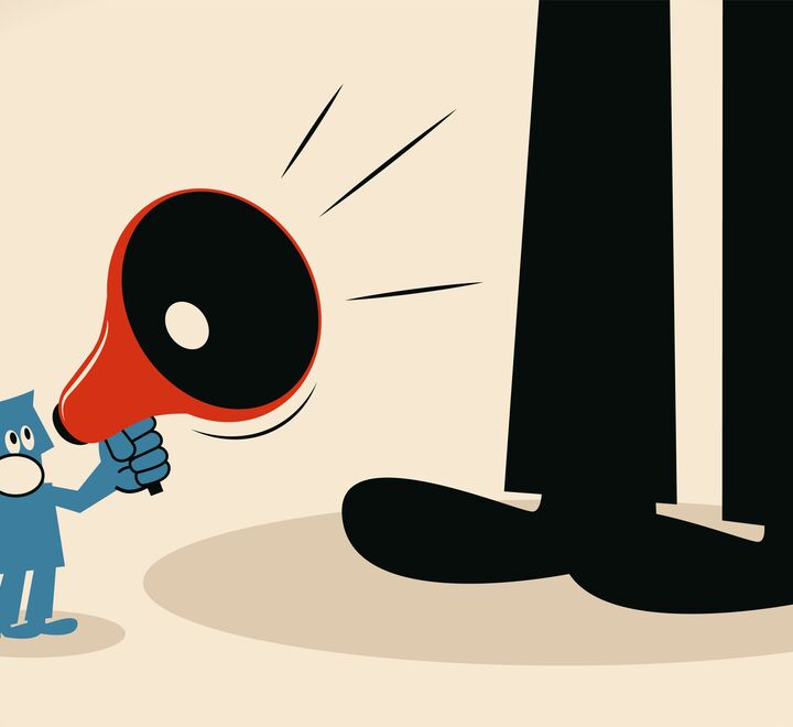 Illustration of small man with microphone shouting a giant black figure