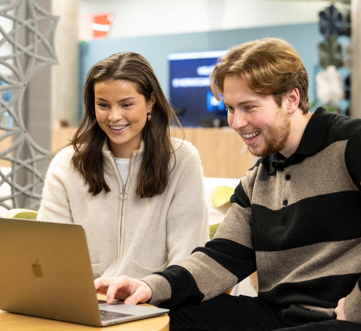 Two students looking at a PC
