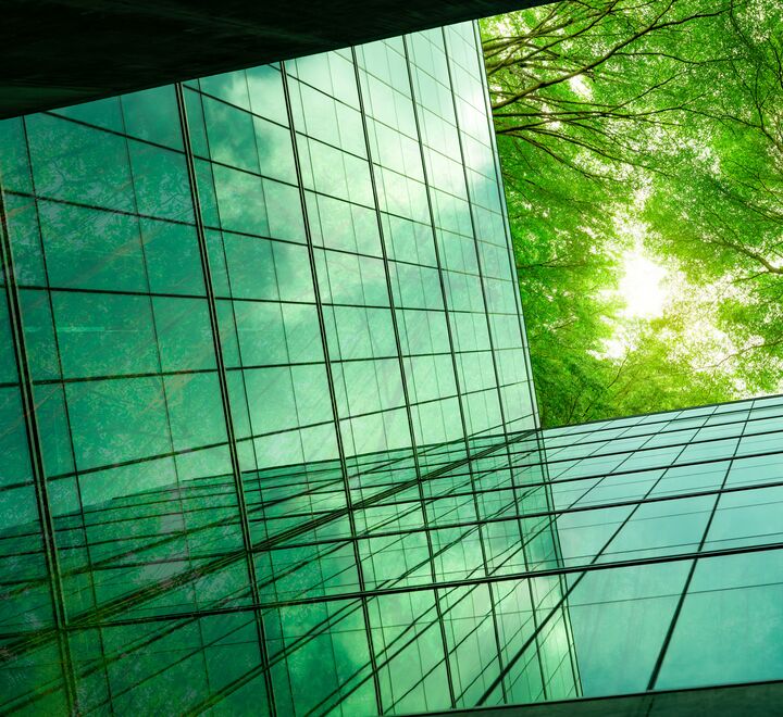 Building with green reflections of the trees