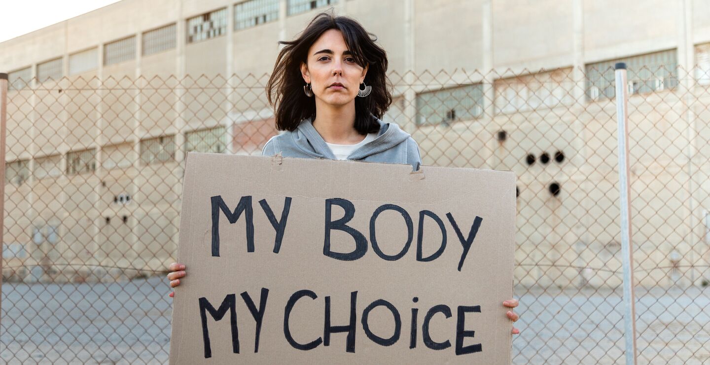 Woman holding sign reading 'My body my choice'