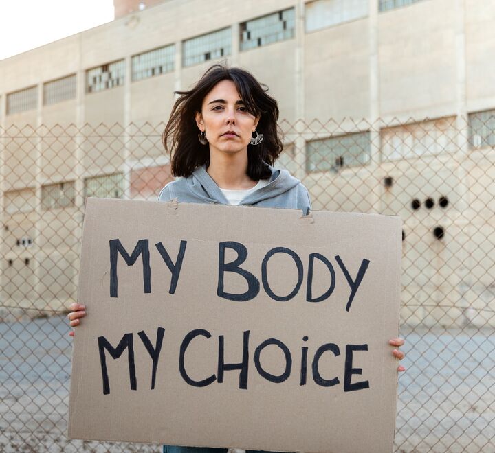 Woman holding sign reading 'My body my choice'