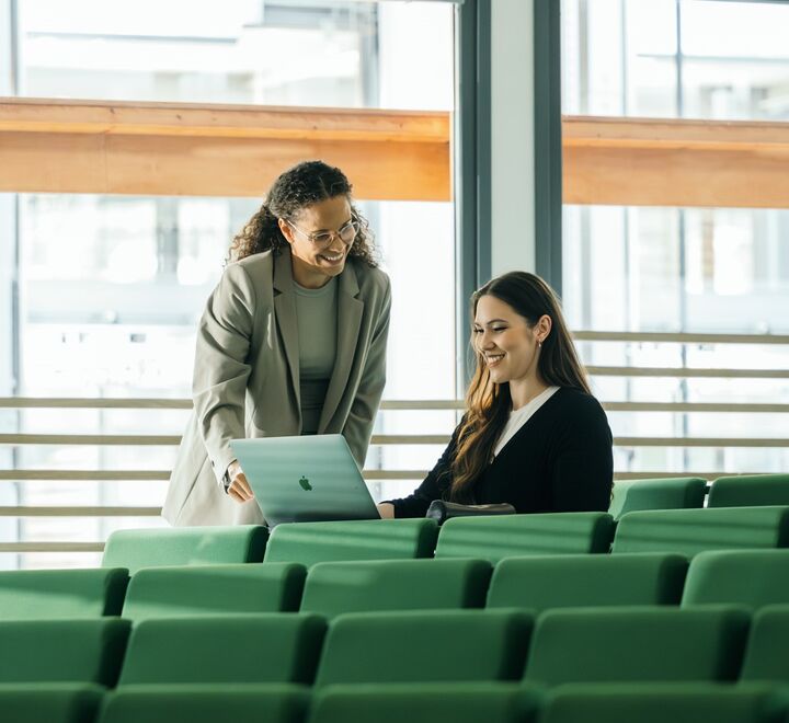Student and professor in an auditorium