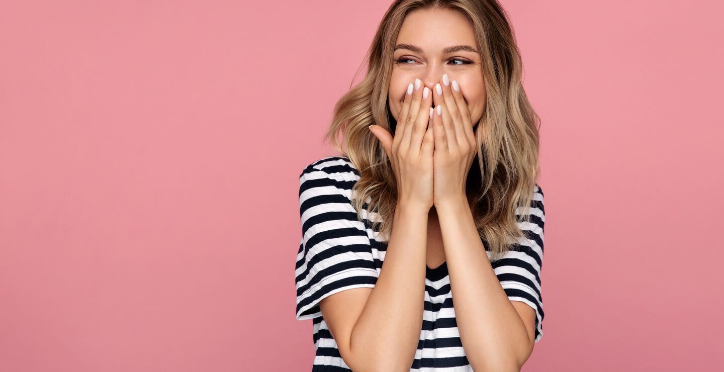 Laughing girl on pink background
