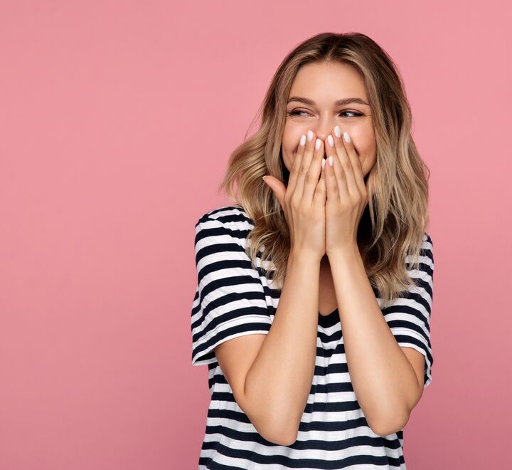 Laughing girl on pink background