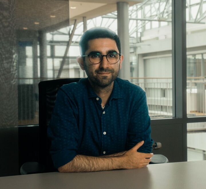 Male PhD candidate in the library at campus Oslo
