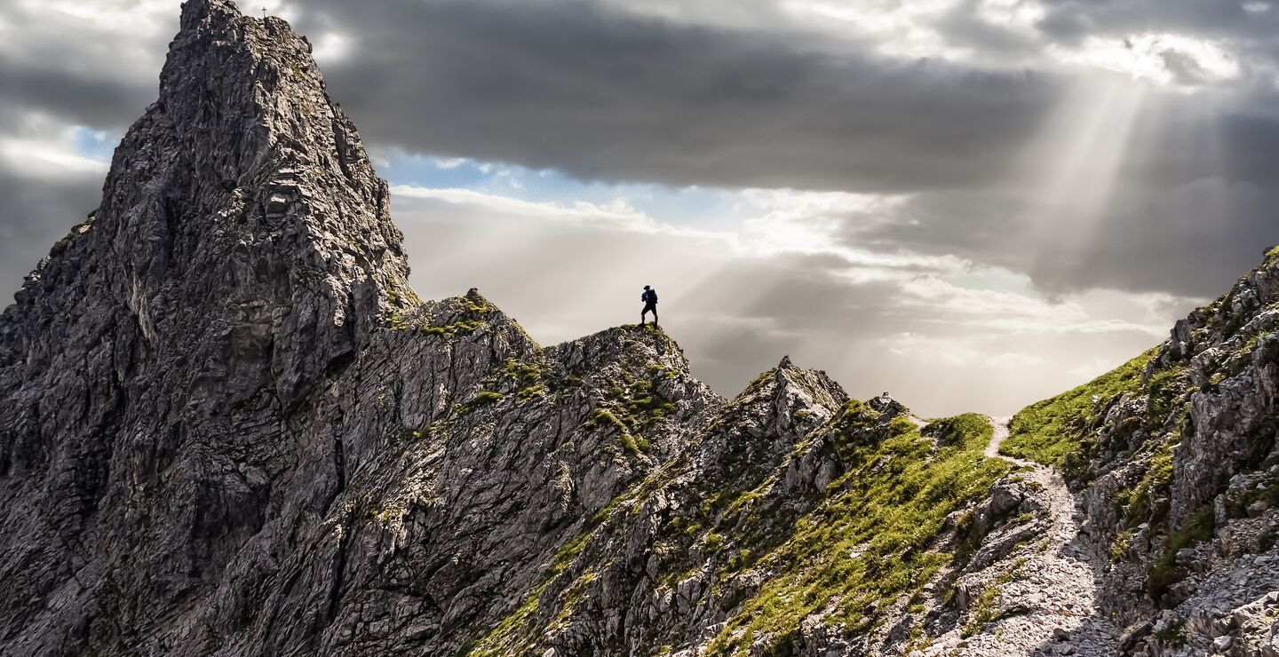 Man standing at the top of a mountain with a great view..
