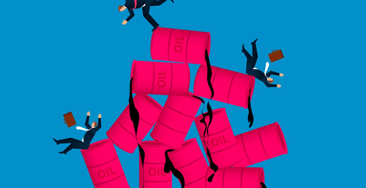 Business men tripping over oil barrels