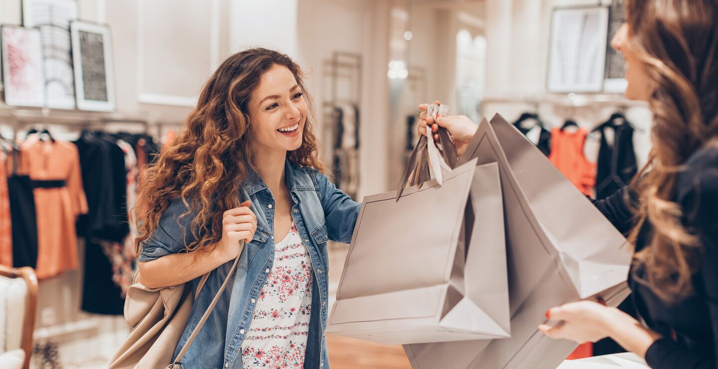 Kvinne med handleposer i butikk