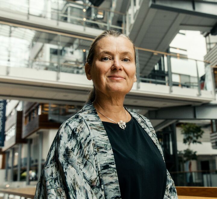 Male student in a suit listening to other students
