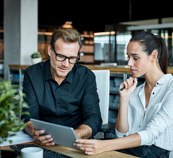 Et bilde av to som ser på samme skjerm