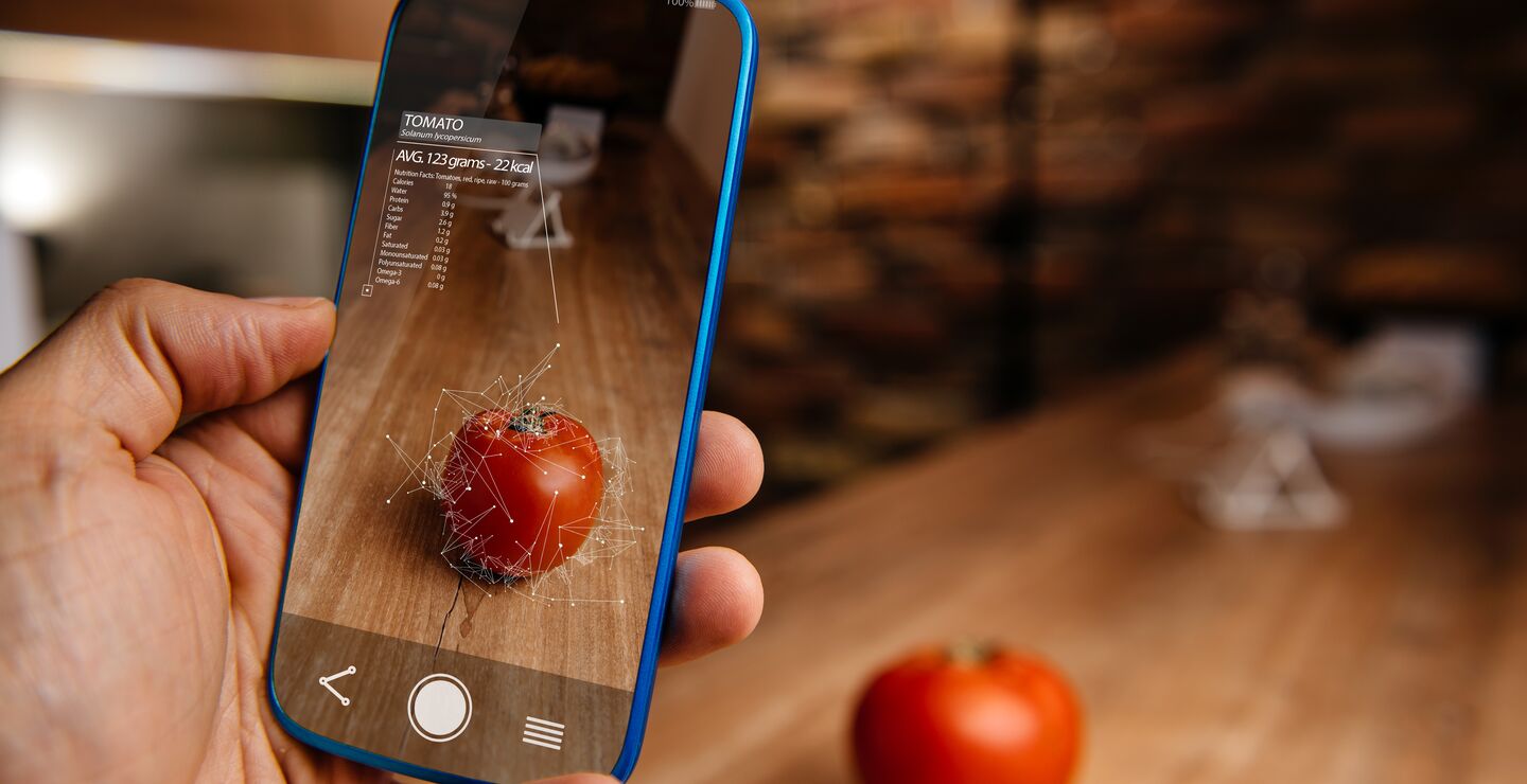 Man using augmented reality application on his phone for recognizing food.
