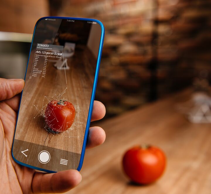 Man using augmented reality application on his phone for recognizing food.