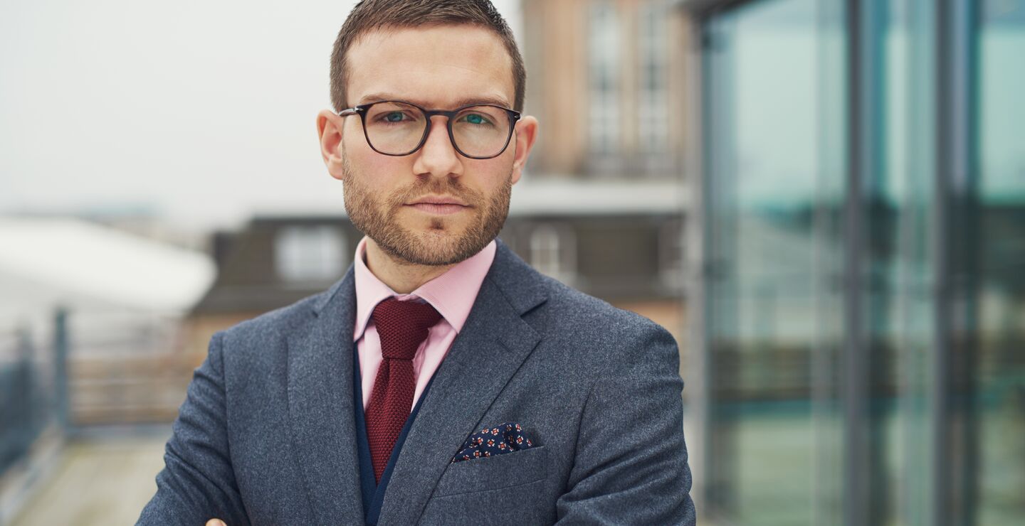 Confident businessman standing outside office