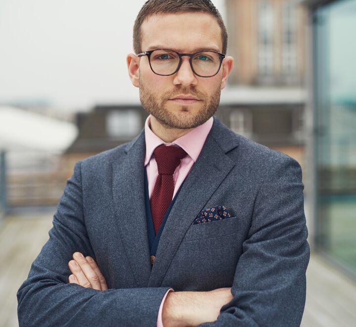 Confident businessman standing outside office