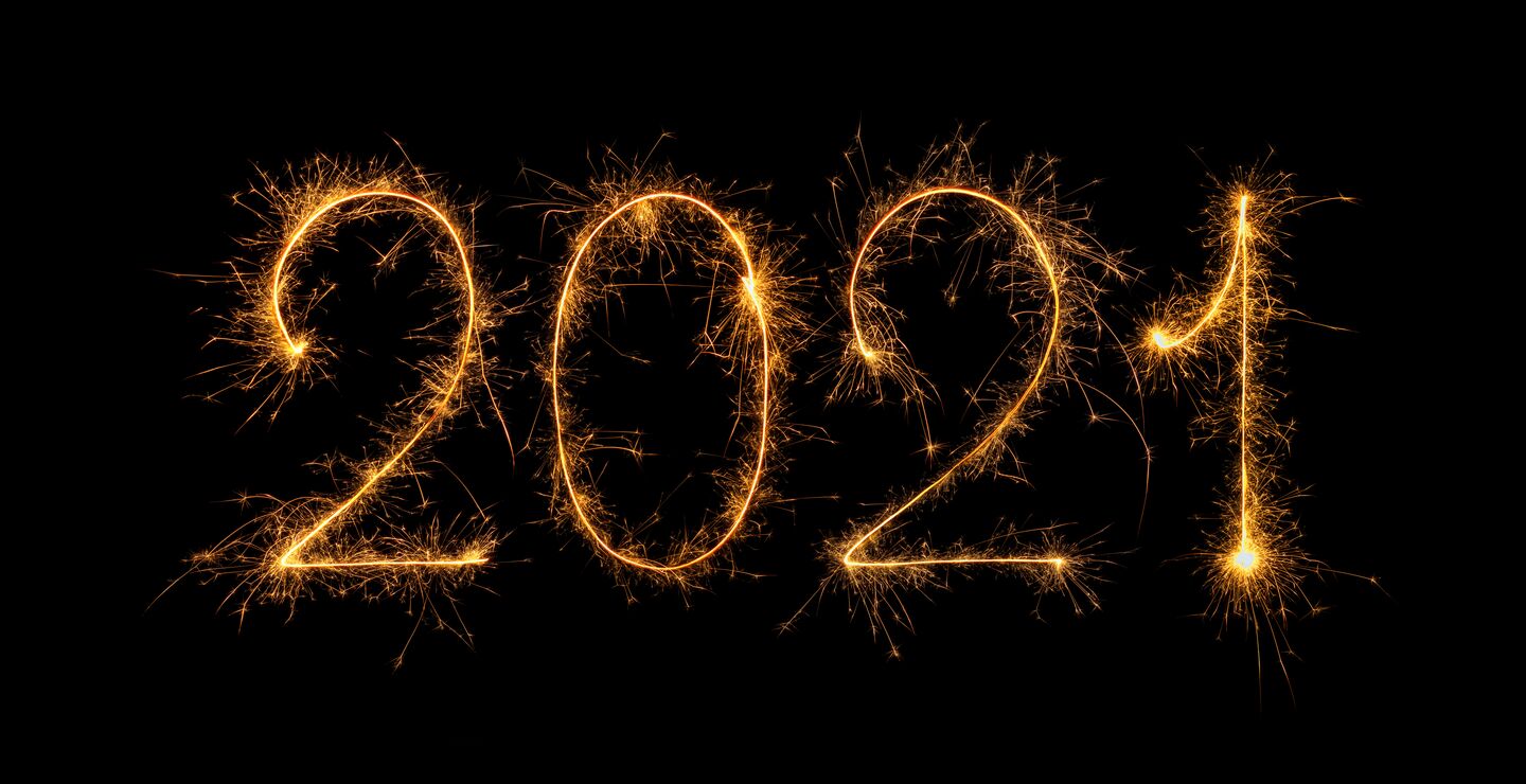 Happy New Year 2021 written with bengal fire, sparkler fireworks candle isolated on a black background.