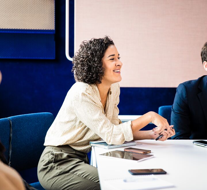 Female sitting at a meeting room table