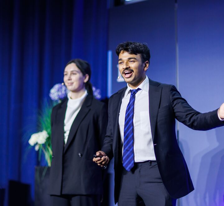 BIICC 2025. A male student presenting in front of the jury.