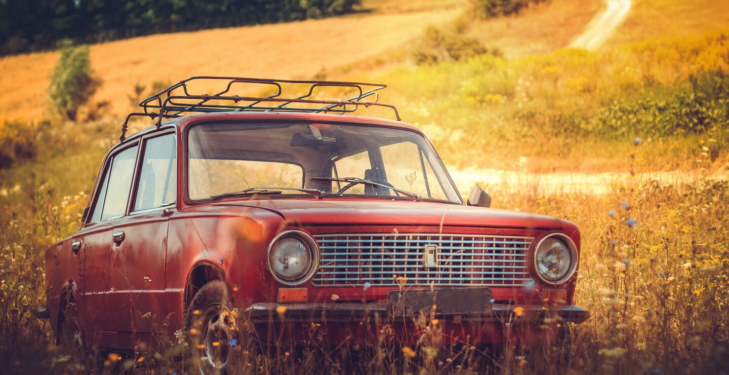 1960-70-tallet var en tid da barn gjerne lå på bilens hattehylle og barneseter knapt nok var oppfunnet. Her en klassisk rød bil fra denne perioden. (Foto: The Nigmatic on Unsplash)