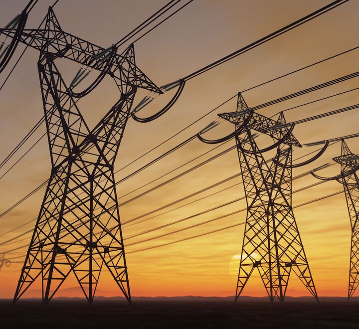 Power lines against setting sun