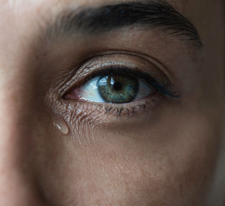 Kvinne med tårer i øynene.