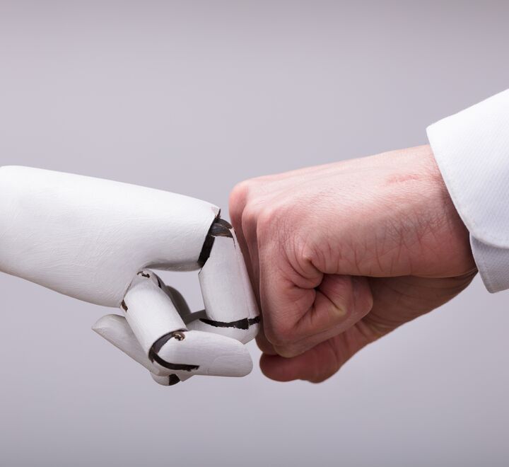 Robot And Human Hand Making Fist Bump On Grey Background.