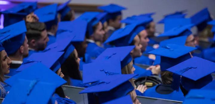 Blue hats during graduation 2023