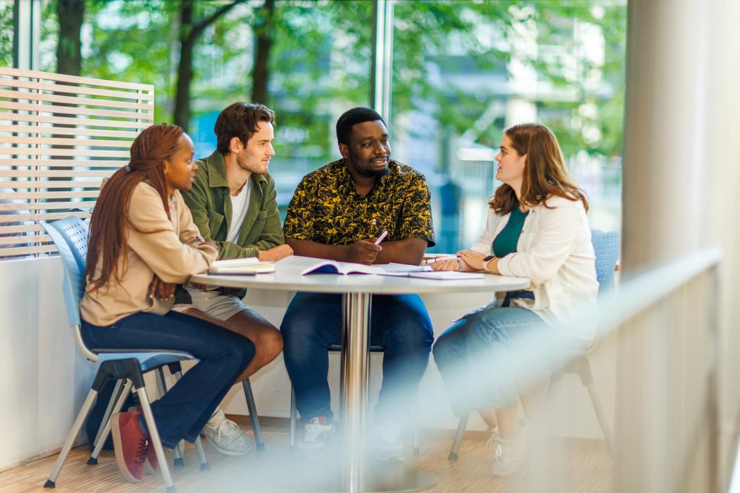 Students talking around a table