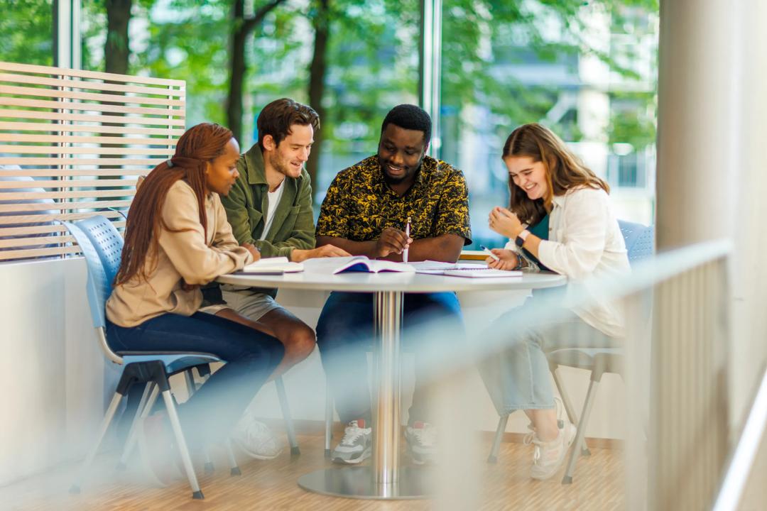 Students at campus sitting around a table