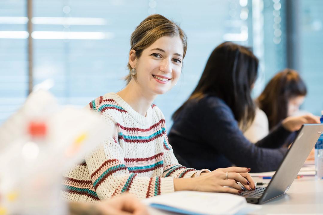 A female student looking at the camera and smiling