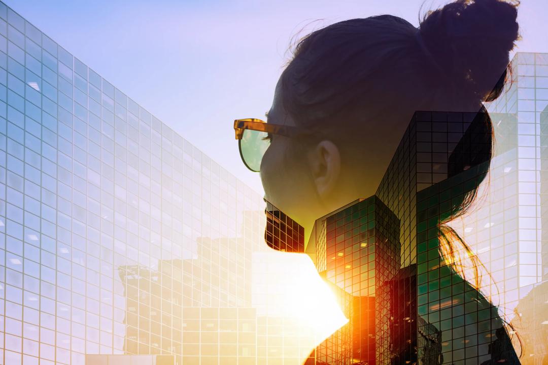 A woman with sunglasses looking at buildings