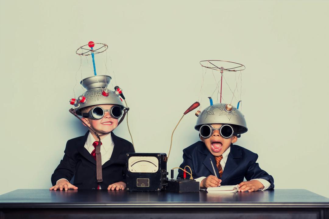 Two children with crazy hats and sunglasses