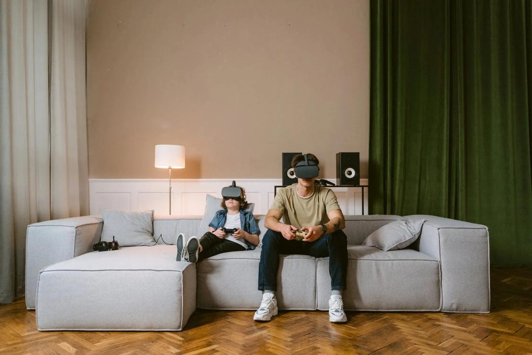 A boy and a man in a couch playing VR games (Image: Tima Miroshnichenko, Pexels)