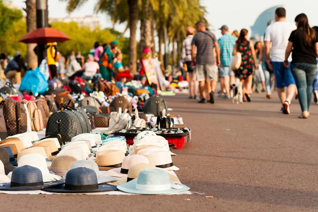 Counterfeit goods displayed on sidewalk in Barcelona