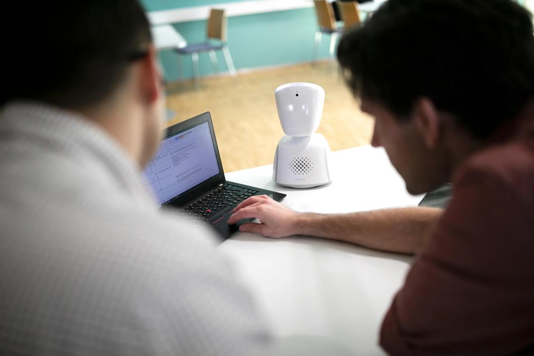 Two people working on a computer