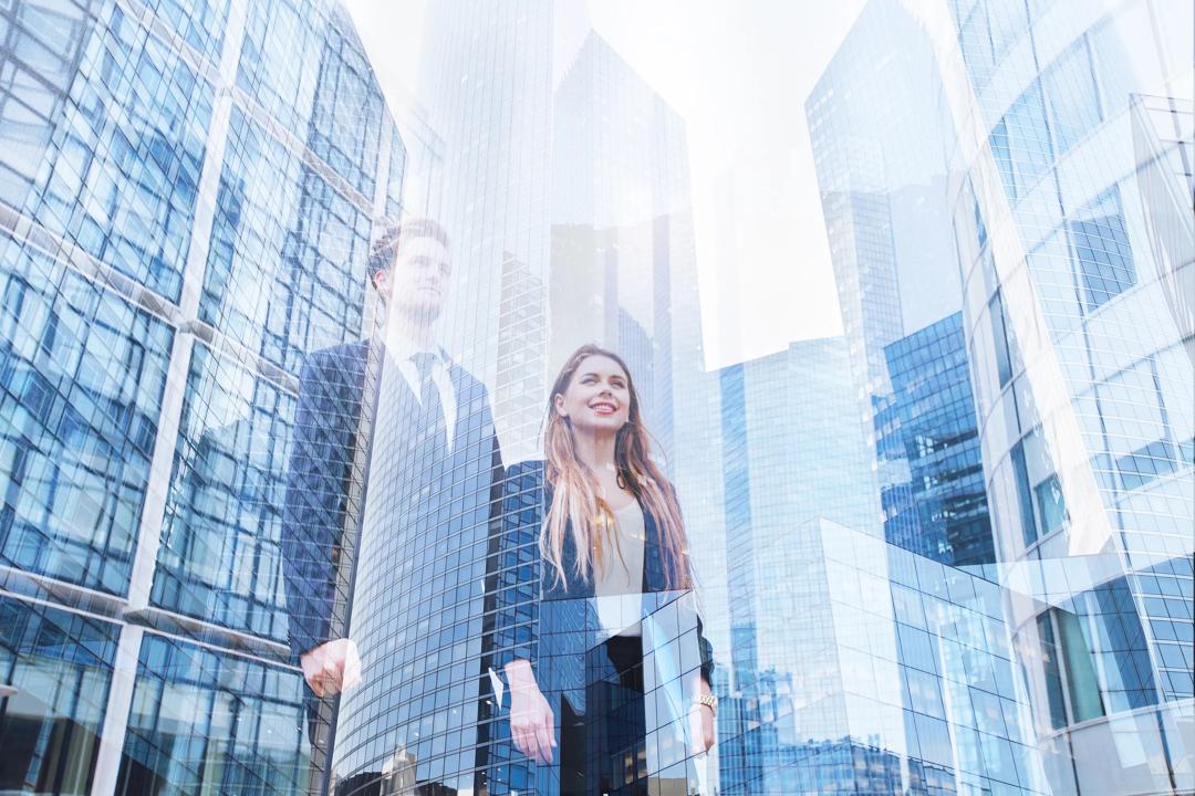  Man and woman looking up at skyscrapers