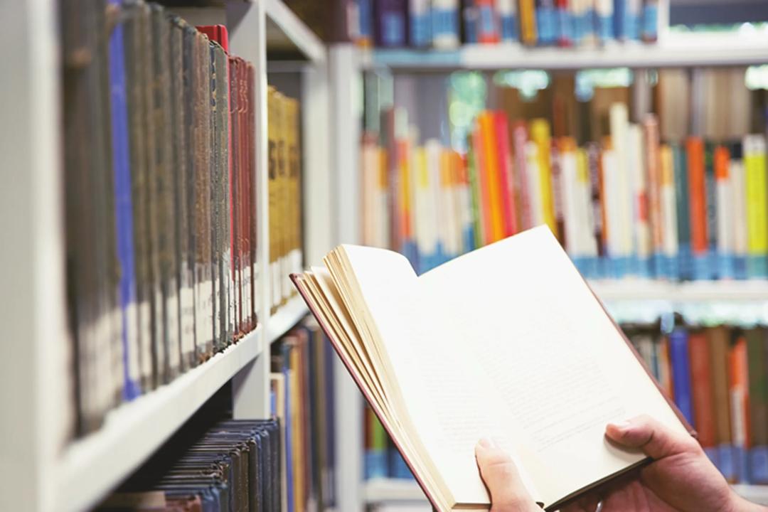 Studenter for pensumhylle i biblioteket