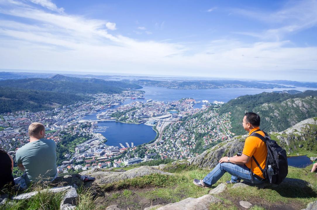 People watching the view of Bergen on top of a mountain 