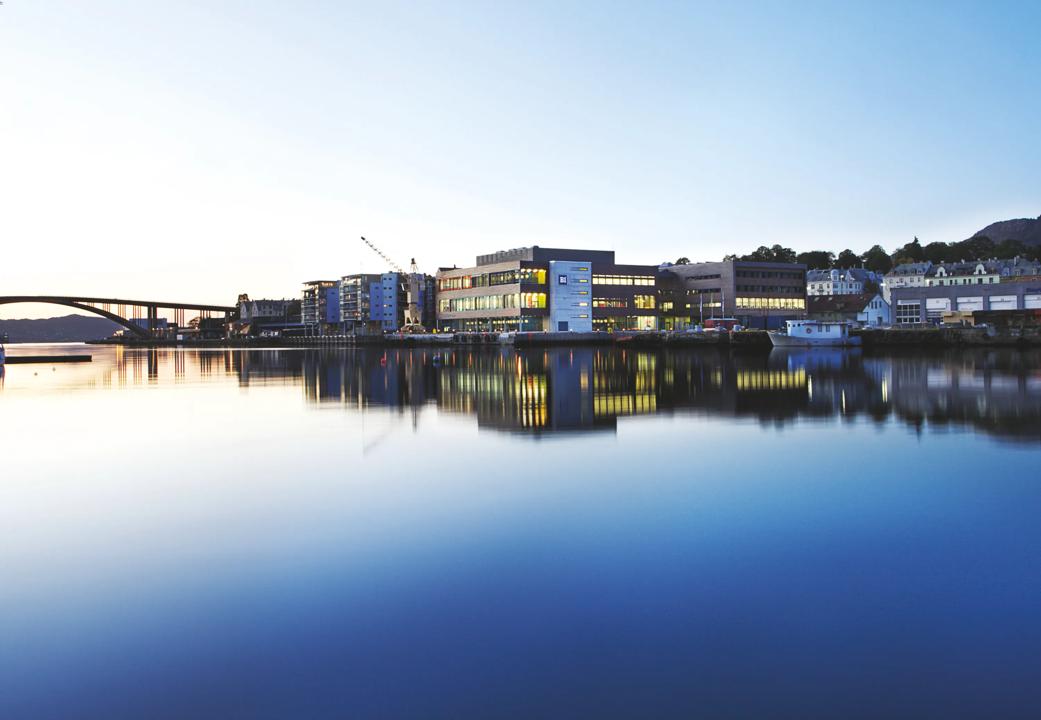 Utenfor campus Bergen. Bilde av vannet og en bro, med BI-bygget i midten.